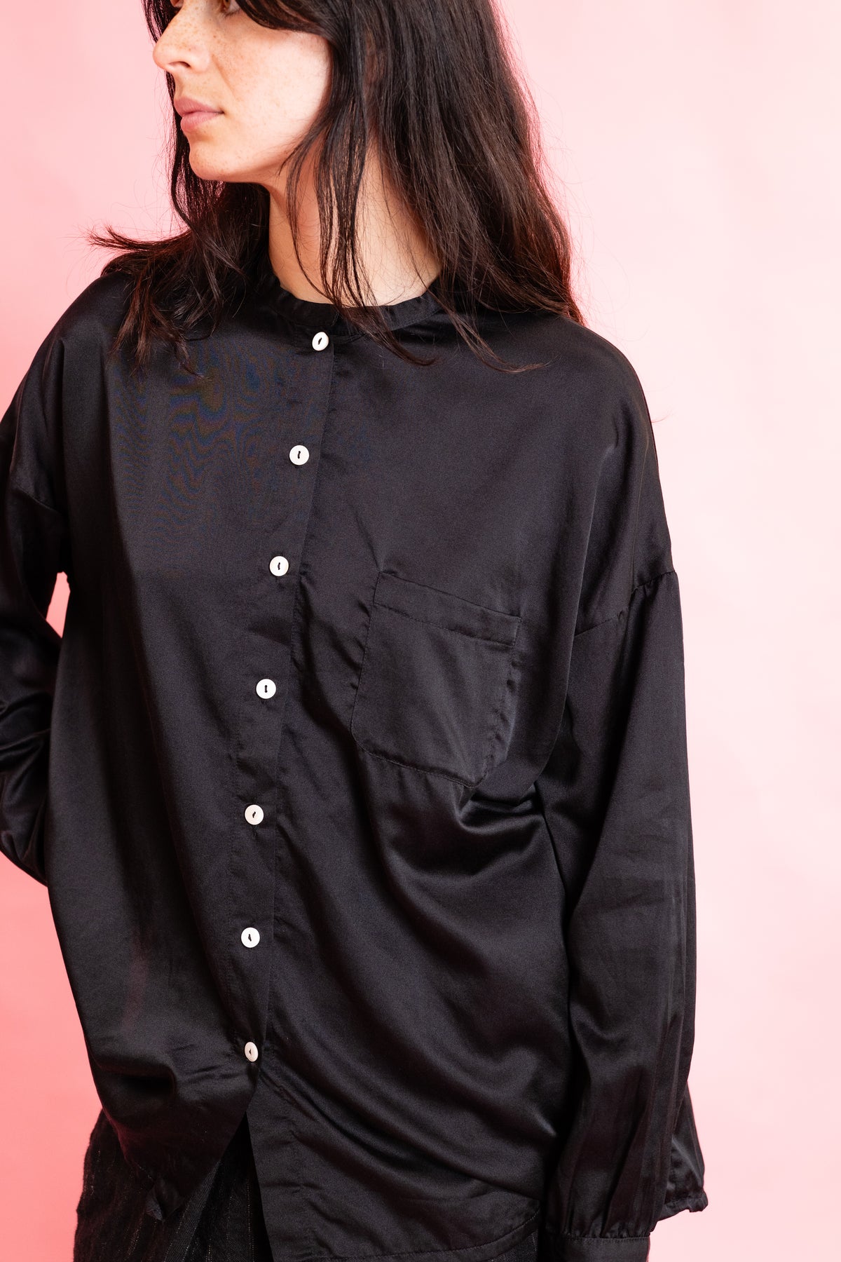 Black silk shirt with a patch pocket detail and mother of pearl buttons at the front
