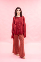 Woman wearing a red outfit on a pink background