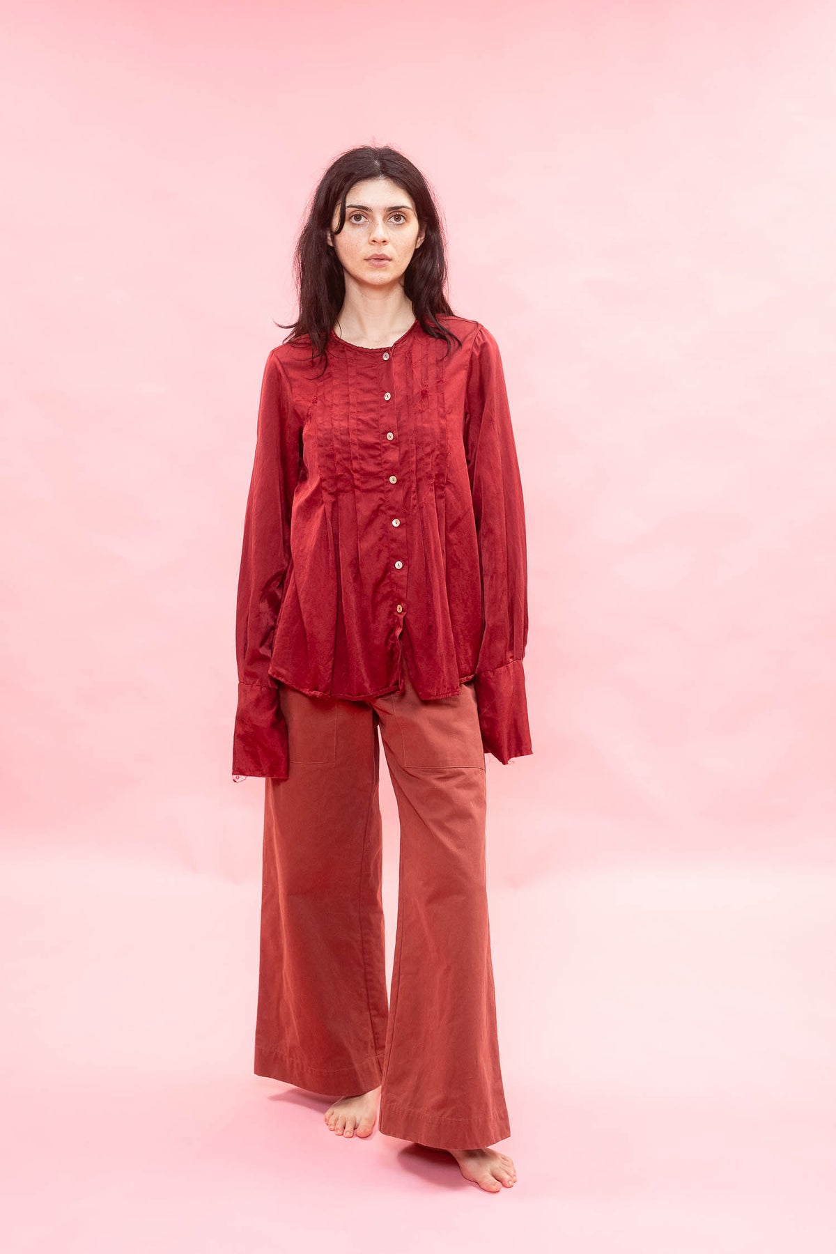 Woman wearing a red outfit on a pink background